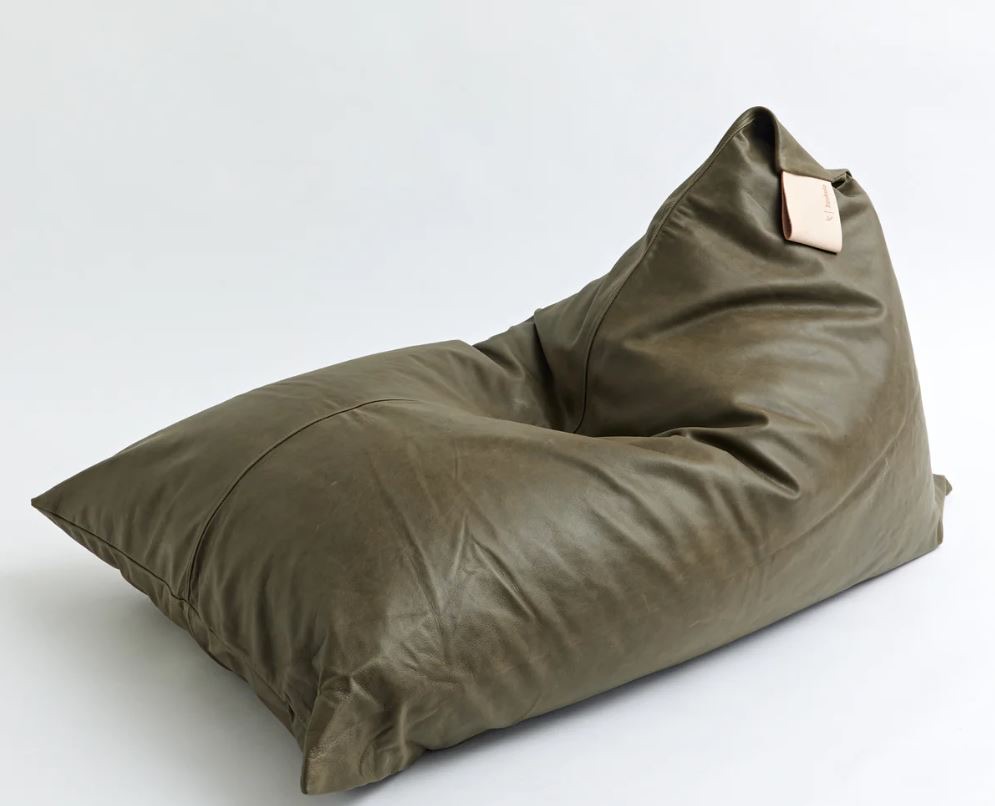 Olive green leather bean bag chair with a rectangular tan leather tag, set against a plain white background.