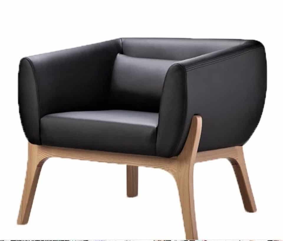 Black cushioned armchair with wooden legs and frame, featuring a modern, boxy design against a plain white background.