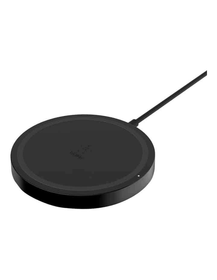 A black wireless charging pad with a circular design and a connected cable, shown on a plain white background.