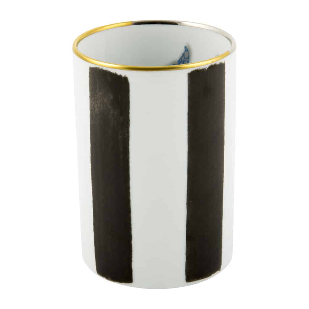 White ceramic cup with vertical black stripes and a gold rim at the top.