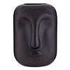 Matte black vase with an abstract face design featuring a prominent nose and closed lips, against a white background.
